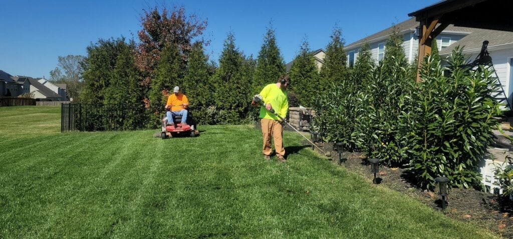 Yard Boys crew mowing and edging a Gulf Coast lawn